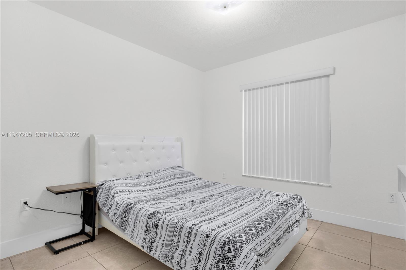 1959 Southeast 10th Street Homestead, FL 33035 - Photo 17 of 39 a bedroom with a bed and a window