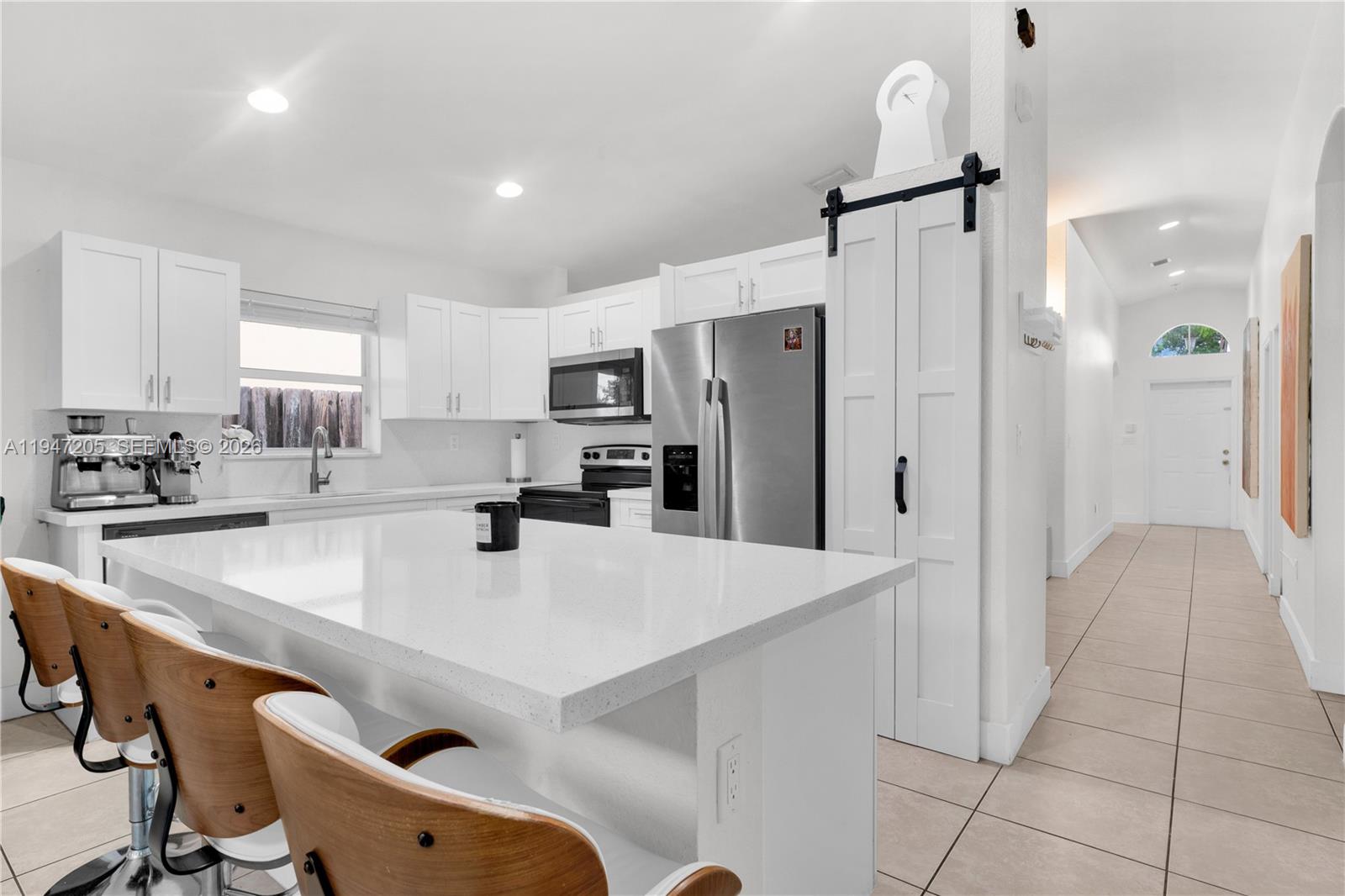 1959 Southeast 10th Street Homestead, FL 33035 - Photo 20 of 39 a kitchen with stainless steel appliances a refrigerator sink and cabinets