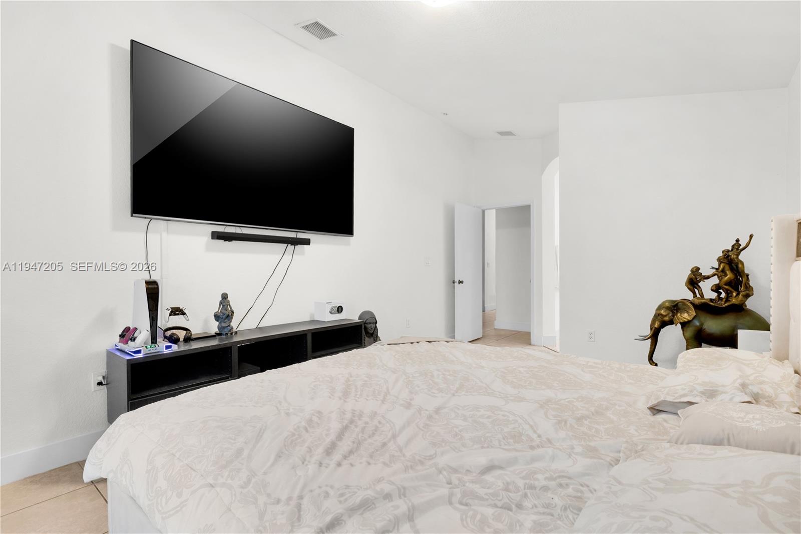 1959 Southeast 10th Street Homestead, FL 33035 - Photo 21 of 39 a bedroom with a bed and a flat screen tv