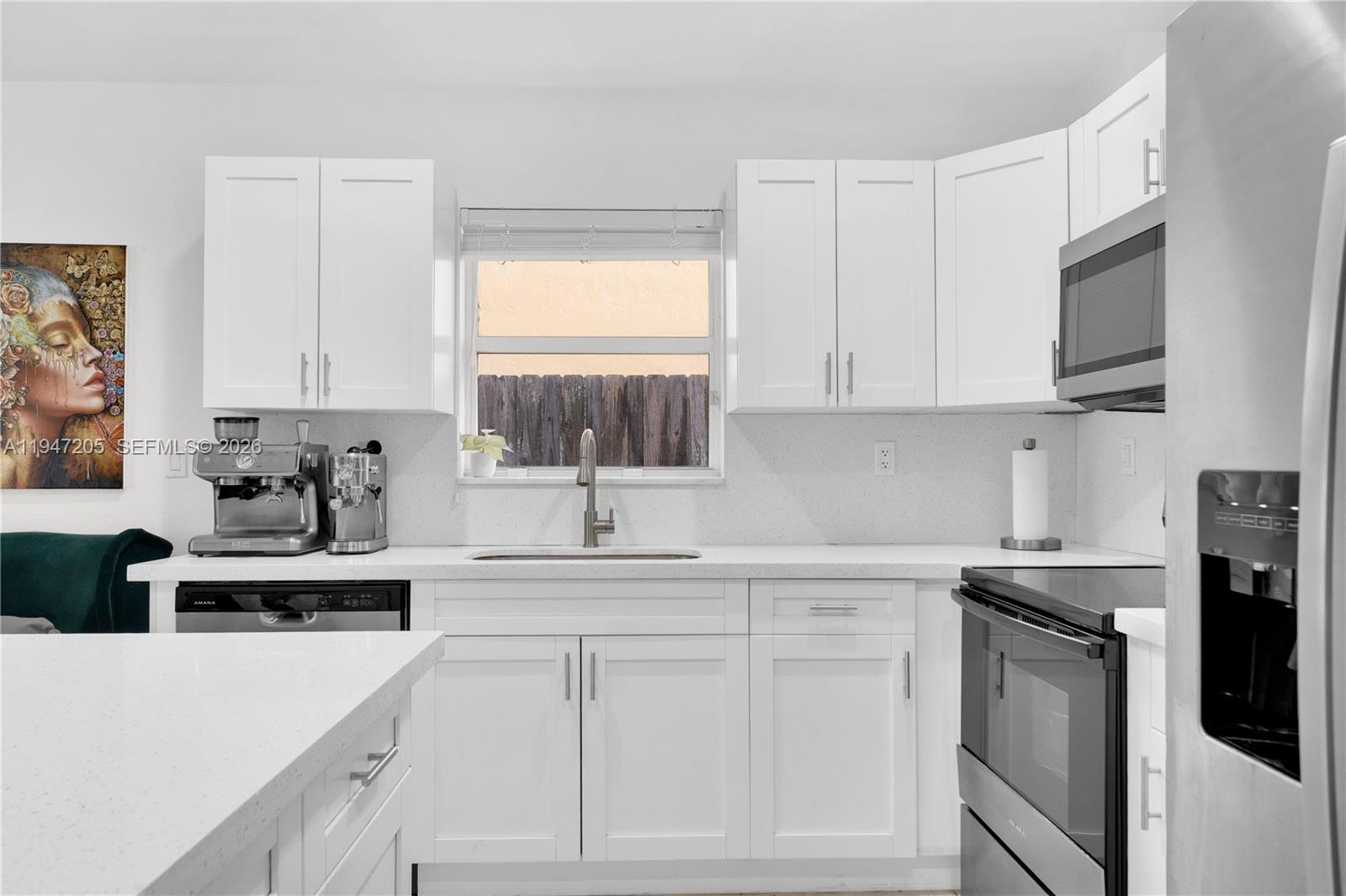 1959 Southeast 10th Street Homestead, FL 33035 - Photo 23 of 39 a kitchen with white cabinets sink and stainless steel appliances
