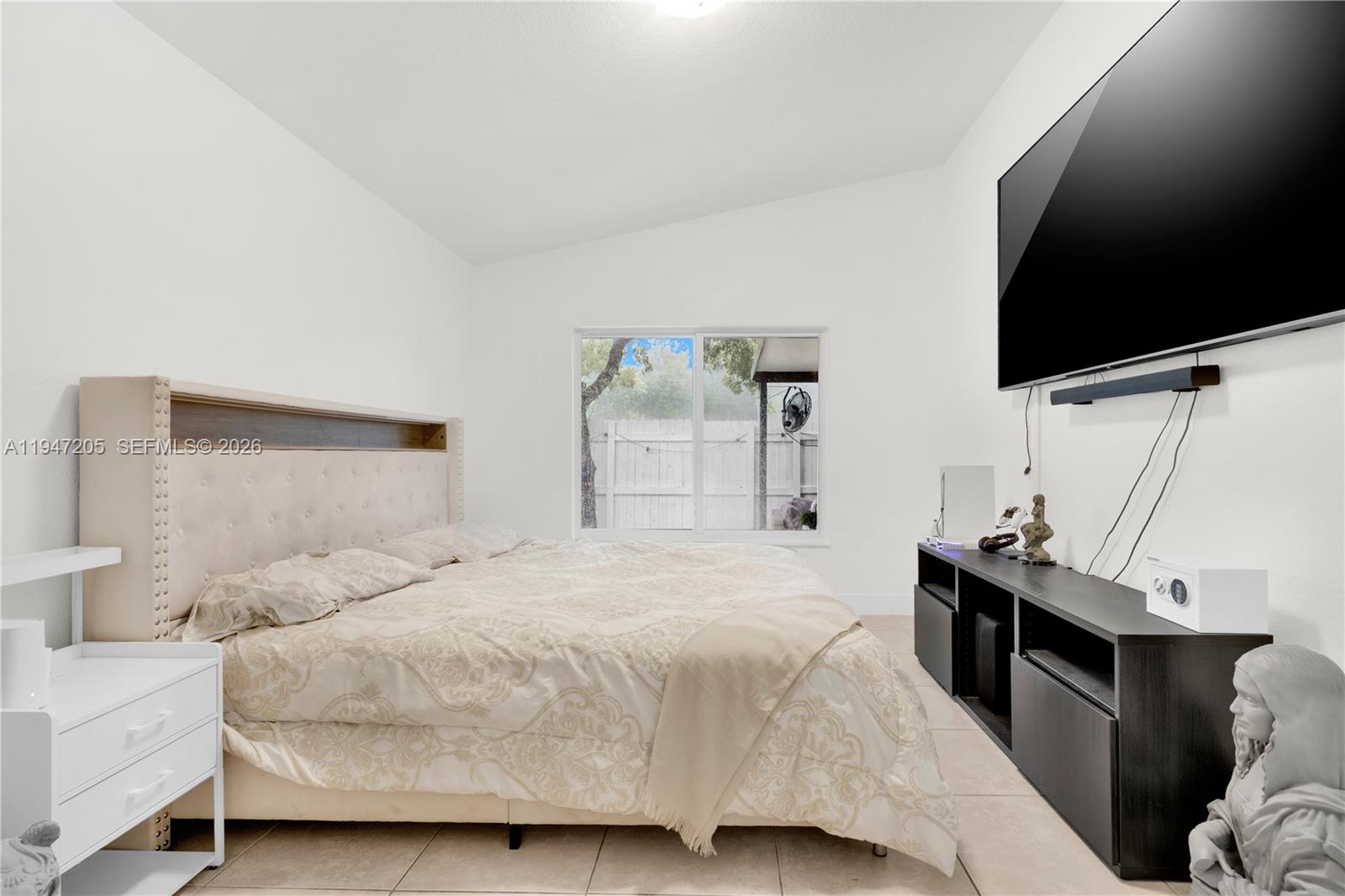 1959 Southeast 10th Street Homestead, FL 33035 - Photo 30 of 39 a bedroom with a bed and a flat screen tv