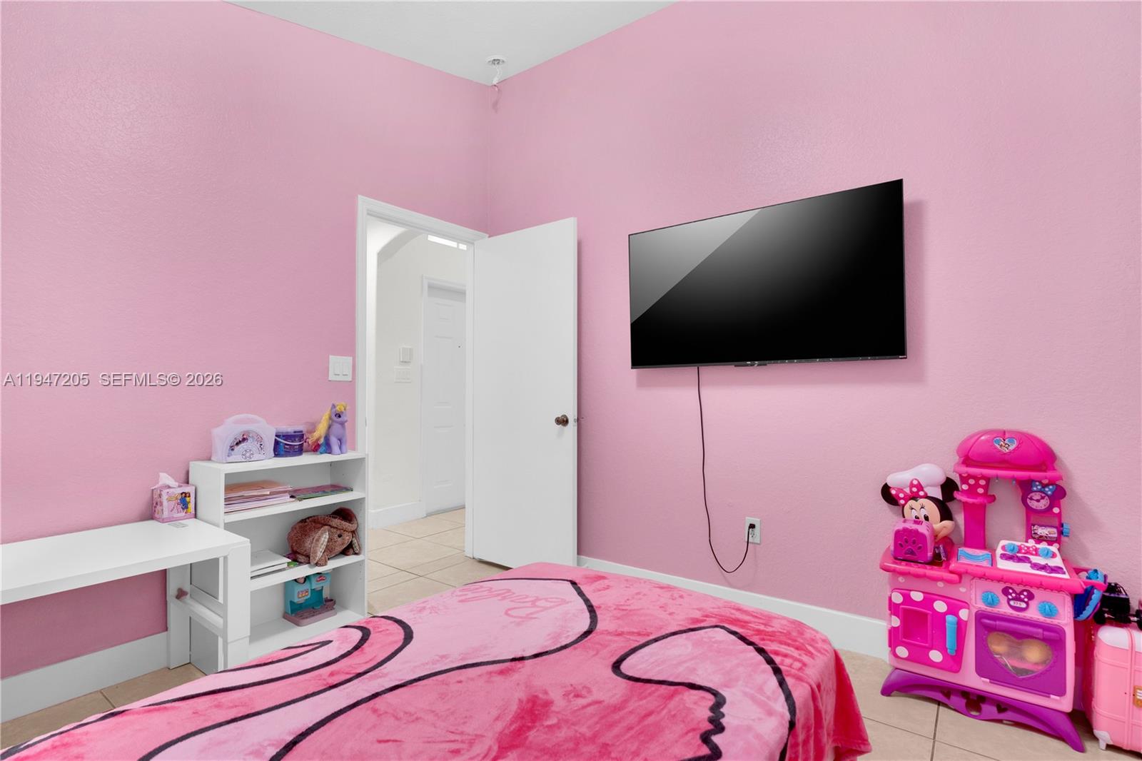 1959 Southeast 10th Street Homestead, FL 33035 - Photo 3 of 39 a bedroom with a bed and a flat screen tv