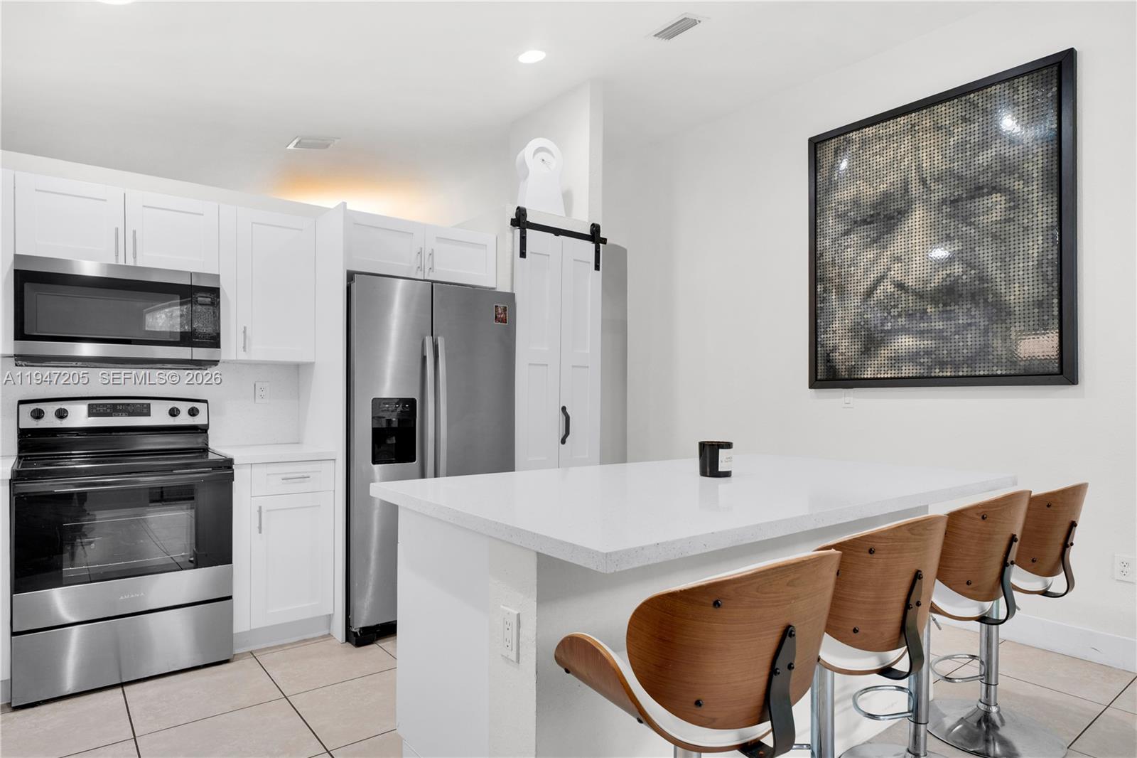 1959 Southeast 10th Street Homestead, FL 33035 - Photo 33 of 39 a kitchen with stainless steel appliances a refrigerator and a stove top oven