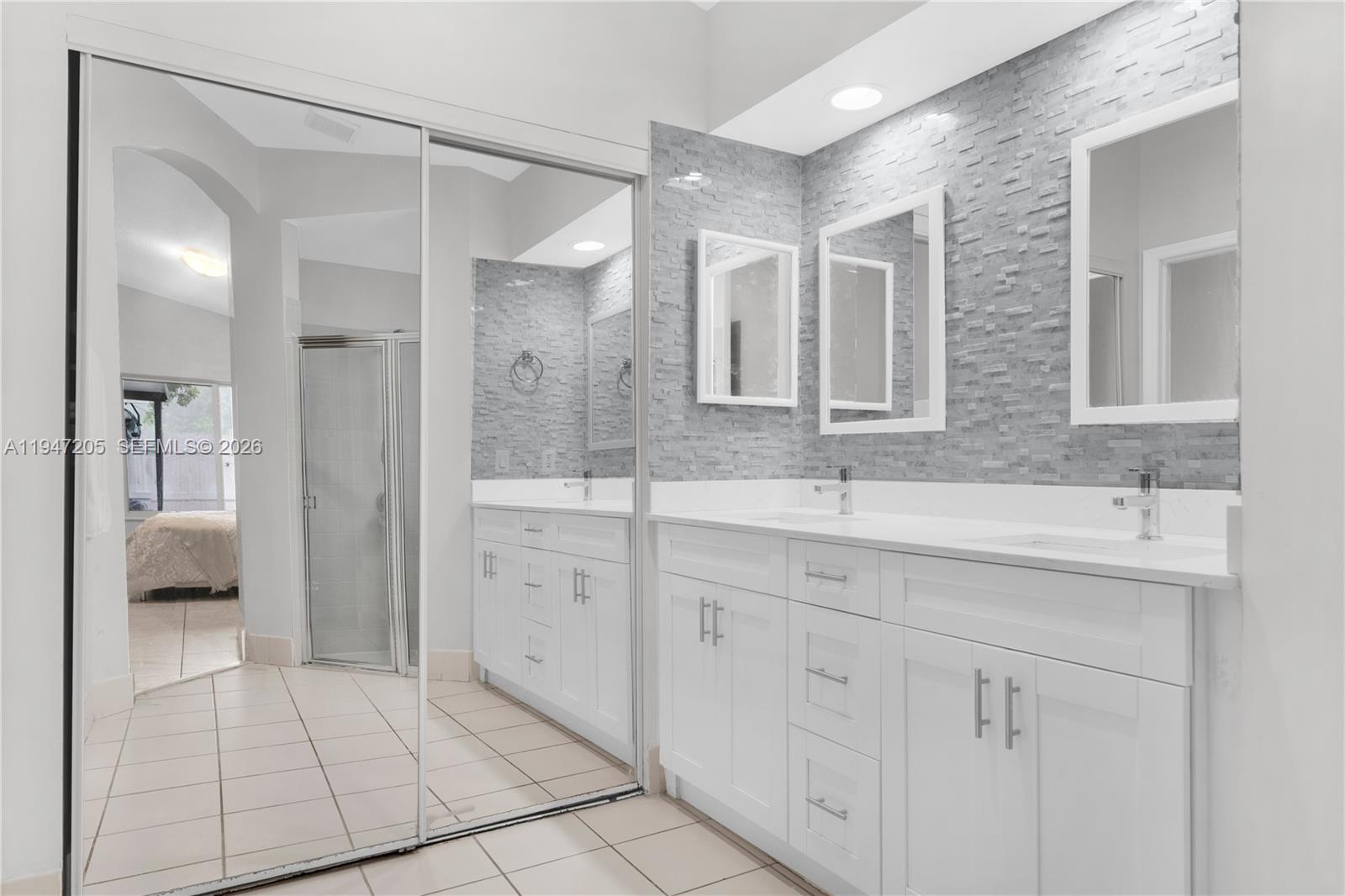 1959 Southeast 10th Street Homestead, FL 33035 - Photo 35 of 39 a spacious bathroom with a shower sink and mirror