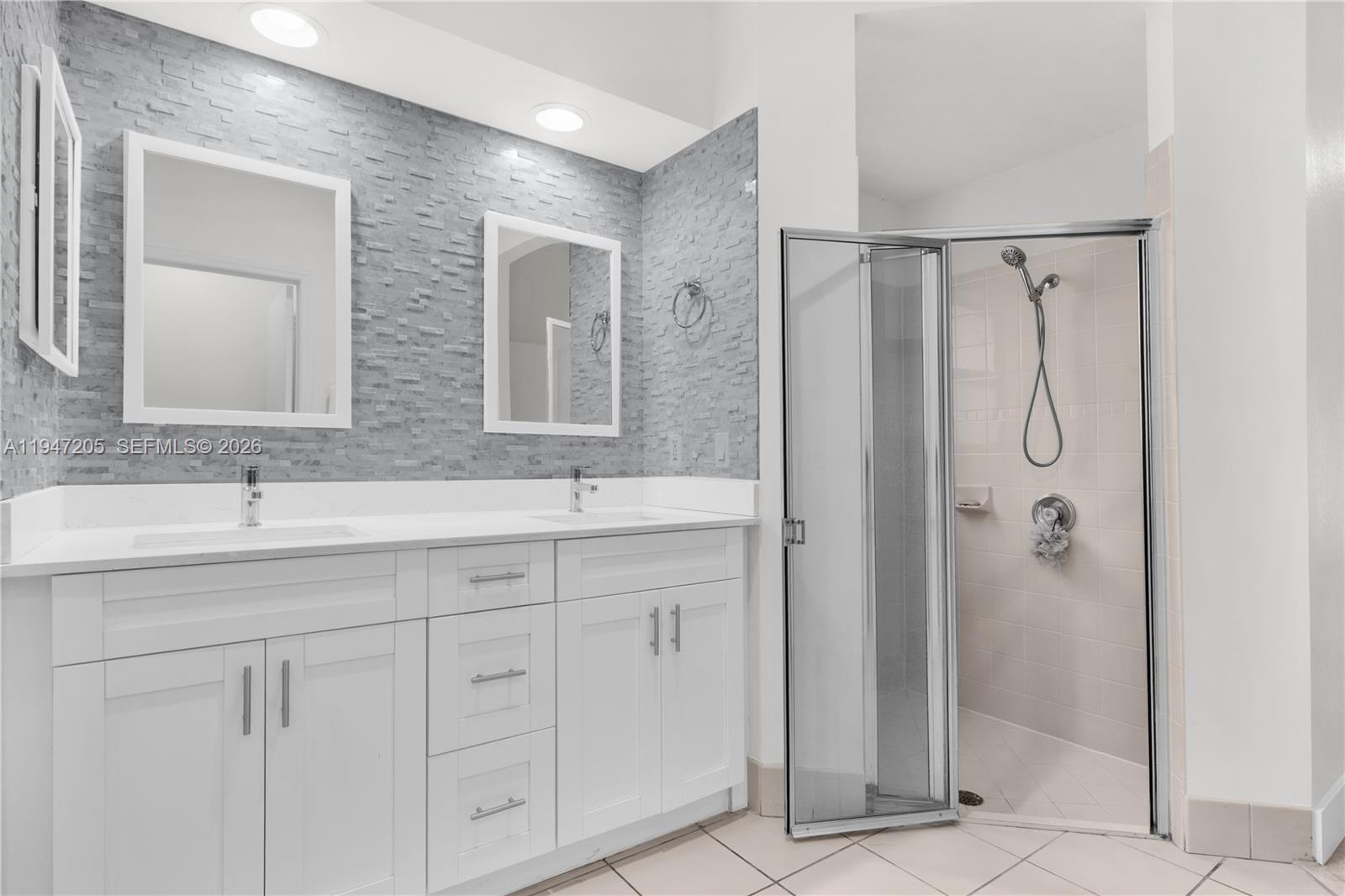1959 Southeast 10th Street Homestead, FL 33035 - Photo 37 of 39 a bathroom with a double vanity sink and mirror