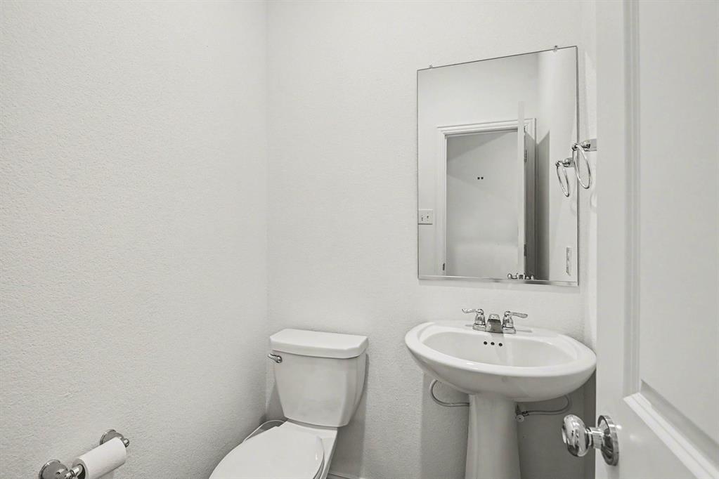 10004 Thornapple Road Fort Worth, TX 76179 - Photo 14 of 39 a bathroom with a sink a toilet and mirror
