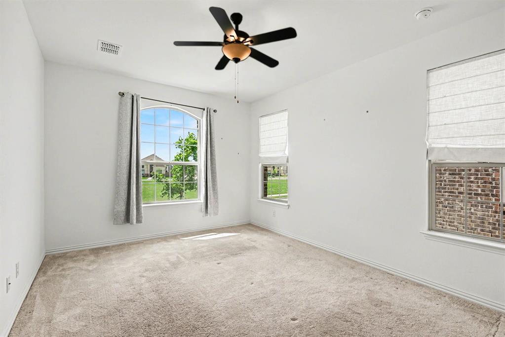 10004 Thornapple Road Fort Worth, TX 76179 - Photo 18 of 39 an empty room with windows and ceiling fan