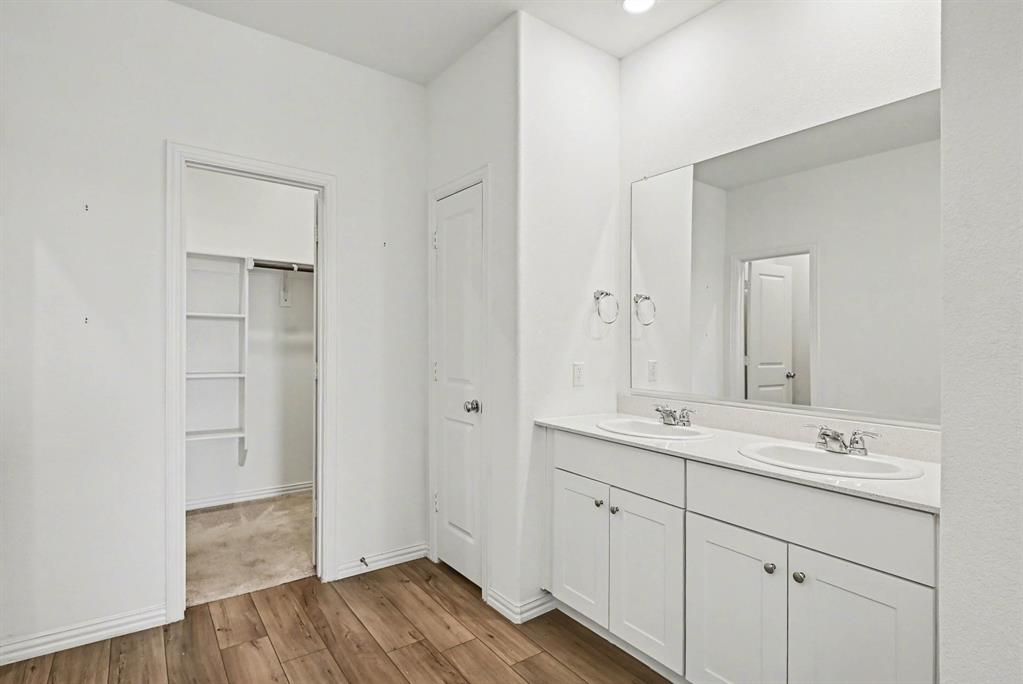 10004 Thornapple Road Fort Worth, TX 76179 - Photo 21 of 39 a bathroom with a double vanity sink and mirror