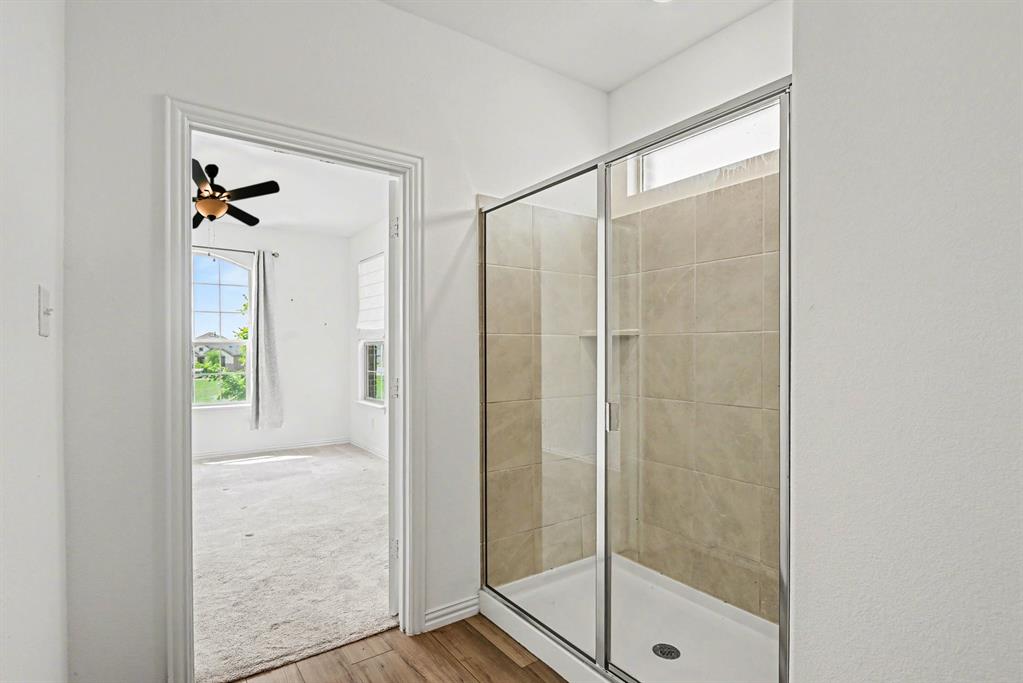 10004 Thornapple Road Fort Worth, TX 76179 - Photo 22 of 39 a bathroom that has a glass shower door