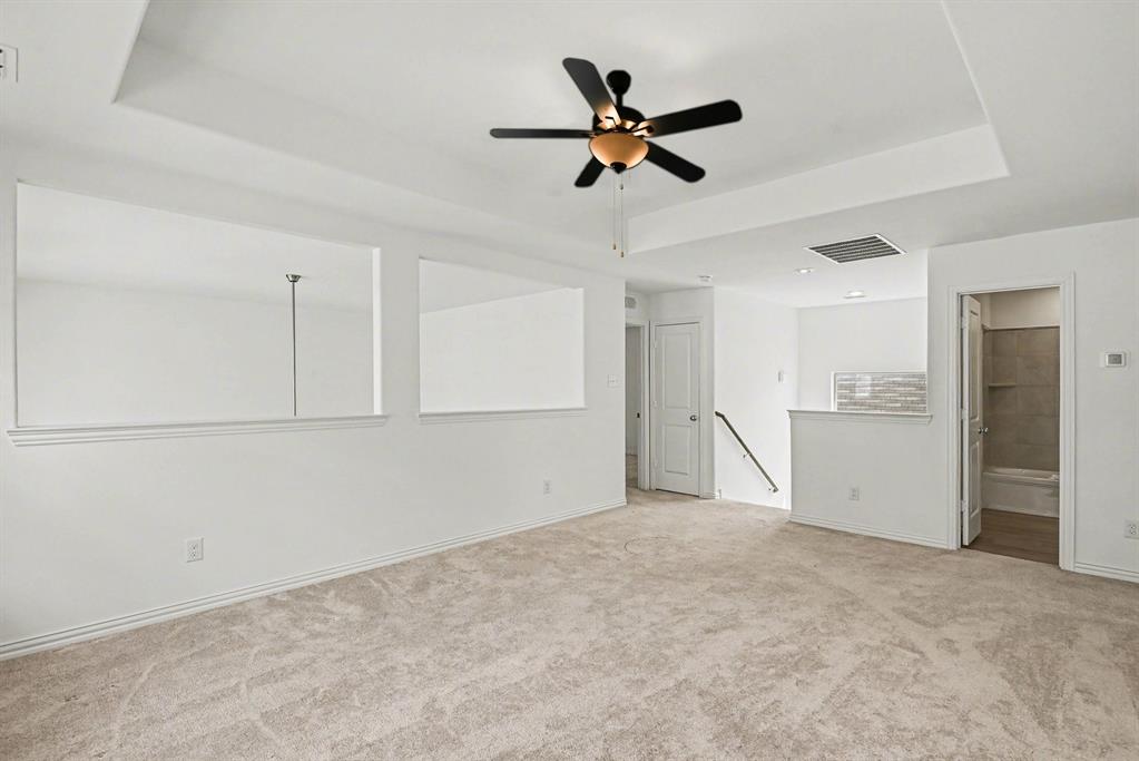 10004 Thornapple Road Fort Worth, TX 76179 - Photo 24 of 39 a view of a livingroom with a ceiling fan and refrigerator