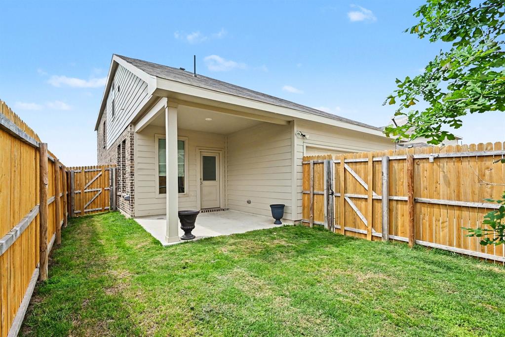 10004 Thornapple Road Fort Worth, TX 76179 - Photo 33 of 39 a view of a backyard with a garden and deck