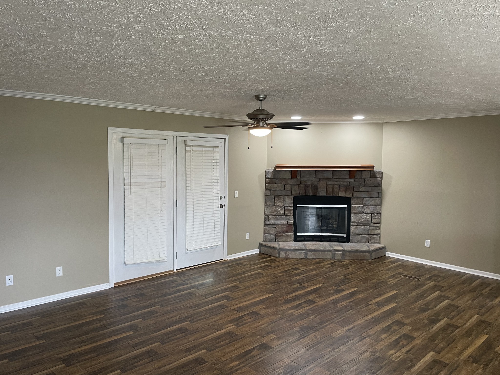 379 Dady Road McEwen, TN 37101 - Photo 23 of 34 a view of an empty room with wooden floor fireplace and a window