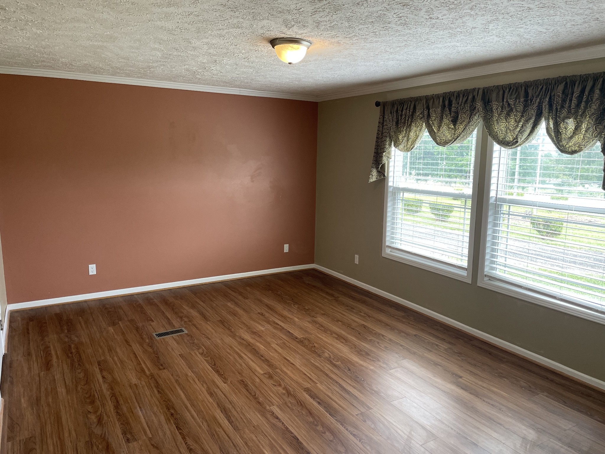 379 Dady Road McEwen, TN 37101 - Photo 25 of 34 a view of an empty room with a window and wooden floor