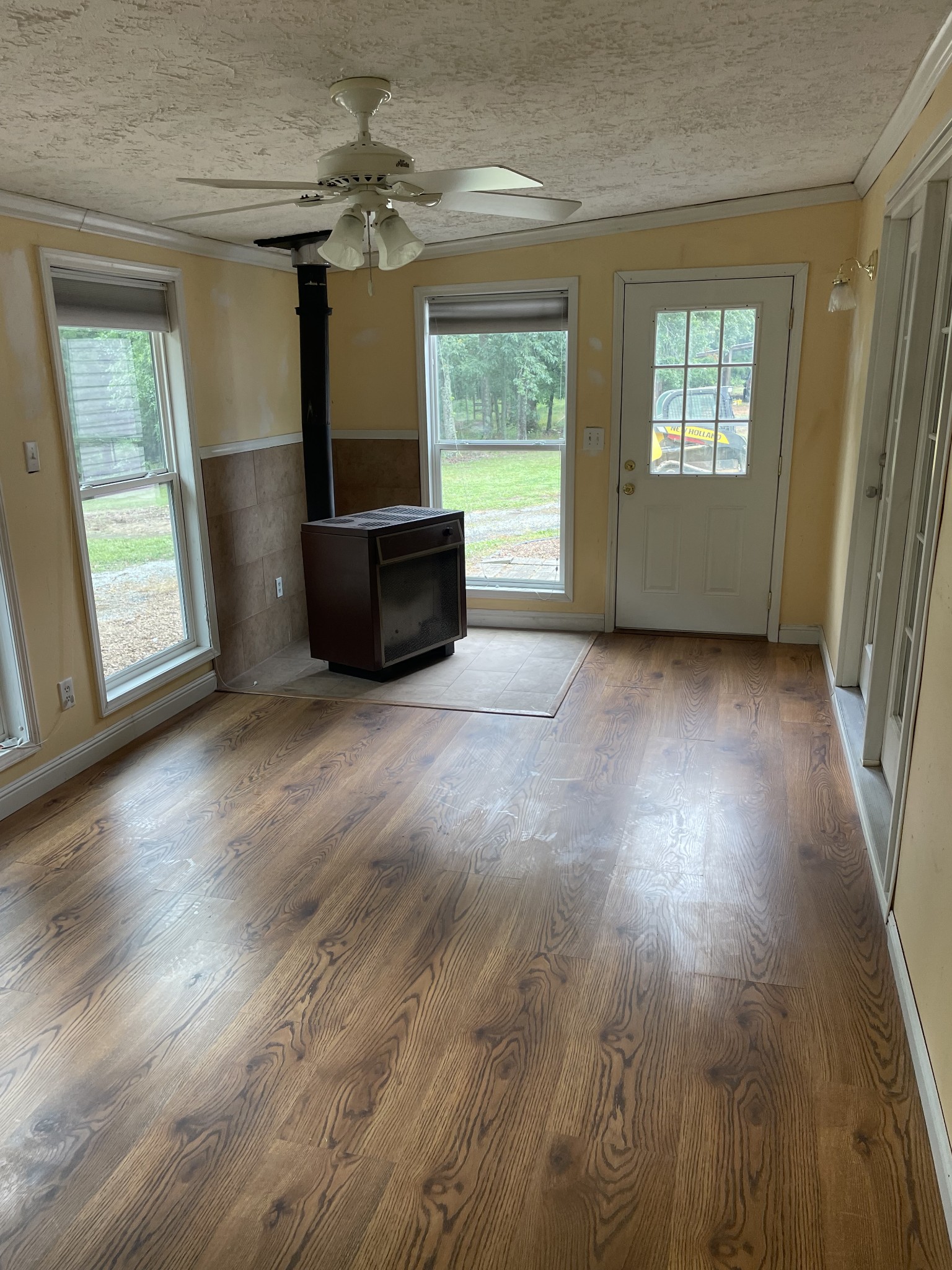 379 Dady Road McEwen, TN 37101 - Photo 29 of 34 an empty room with windows a fireplace and wooden floor