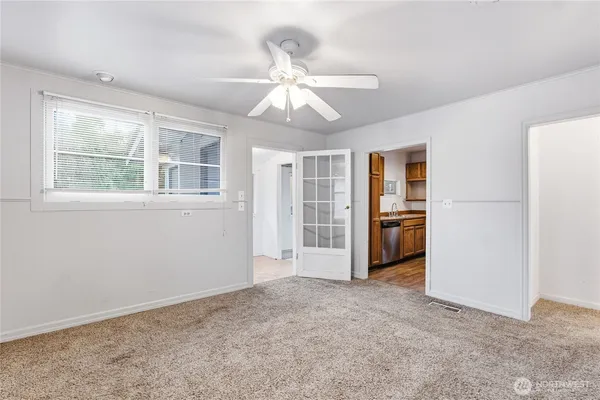 an empty room with windows and cabinet