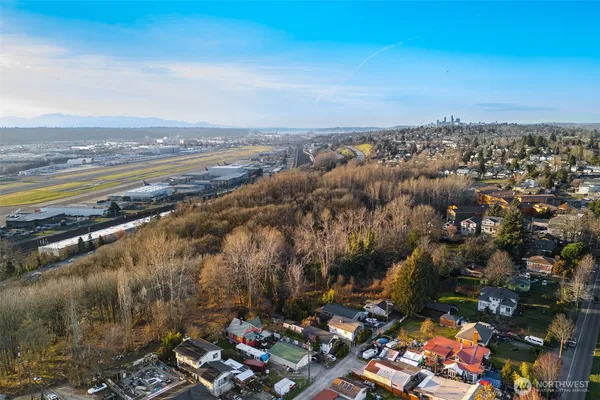 an aerial view of a house with a garden and lake view
