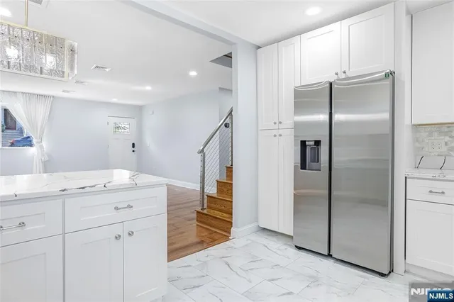 a kitchen with a refrigerator and a sink