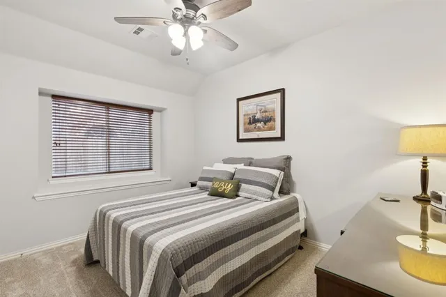 a view of a patio with table and chairs and potted plants