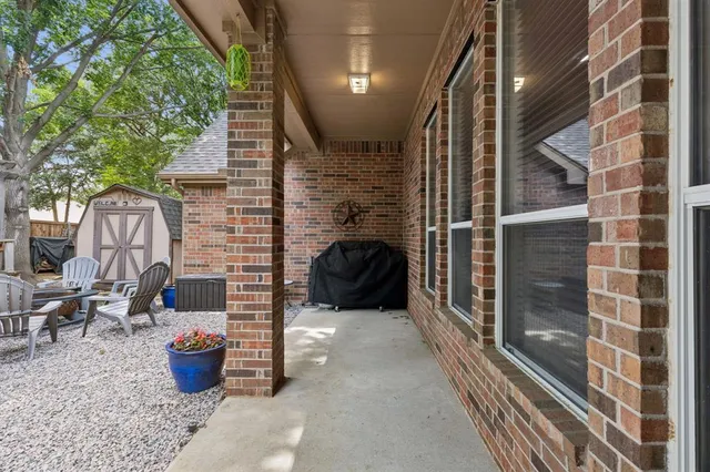 a floor to ceiling window and potted plants
