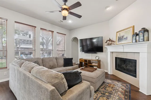 a living room with furniture flat screen tv and a fireplace