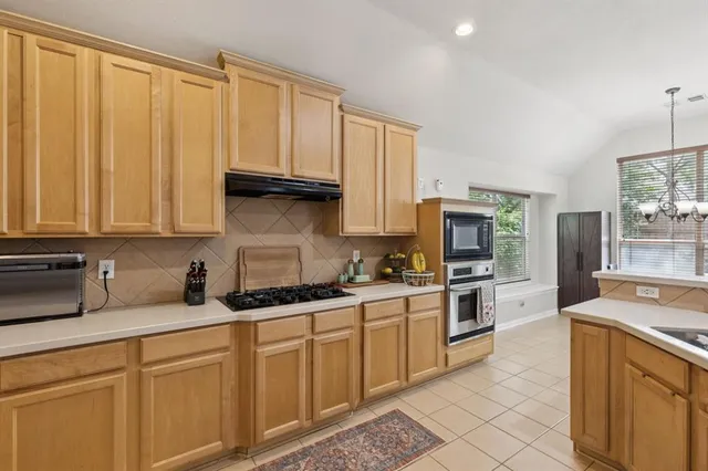 a kitchen with a sink a counter top space and appliances