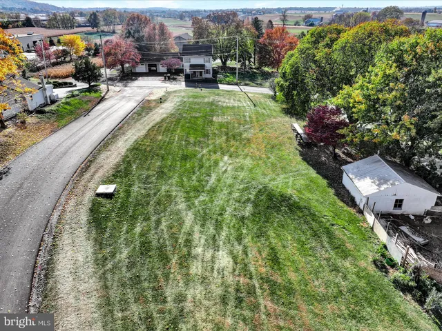 an aerial view of a house with yard swimming pool and outdoor seating
