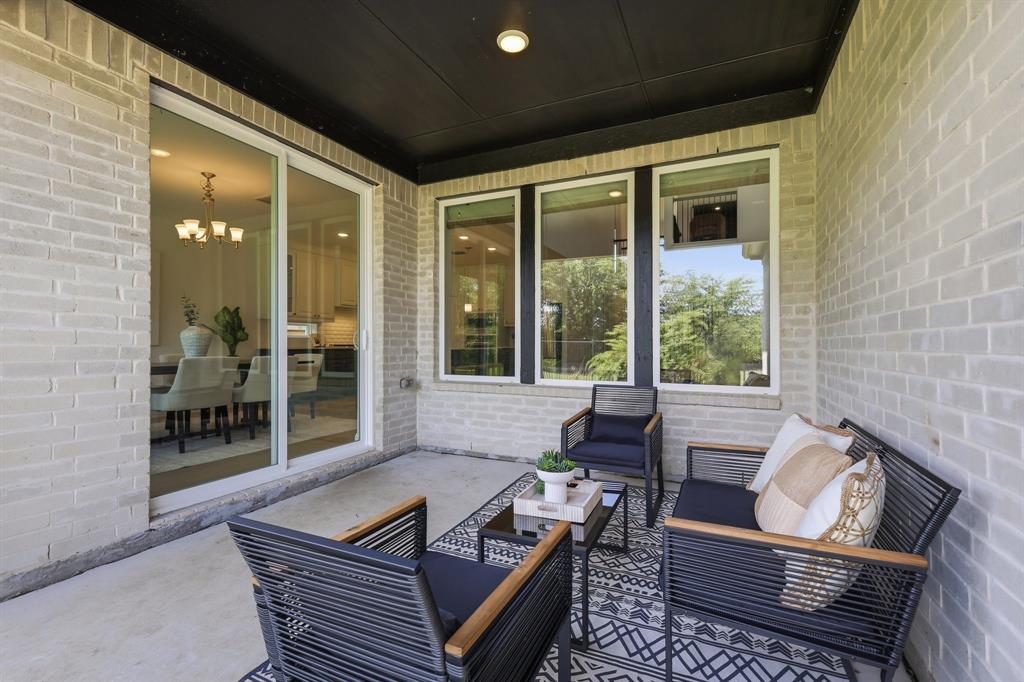 539 Farrell Lane Allen, TX 75013 - Photo 33 of 39 Covered patio featuring a light brick exterior, concrete flooring, and a dark soffit