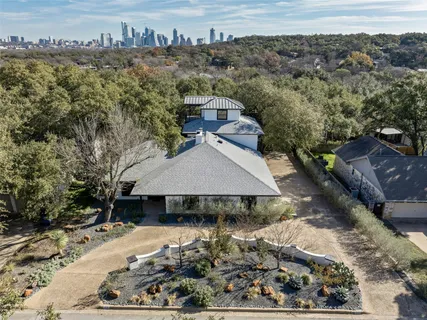 an aerial view of a house with a yard basket ball court and outdoor seating
