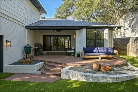 a view of a house with backyard porch and sitting area