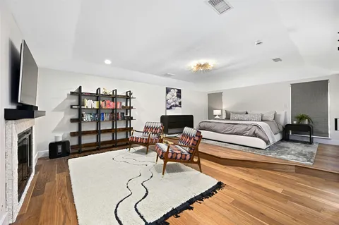a living room with fireplace furniture and a flat screen tv