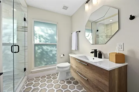 a bathroom with a sink toilet and mirror