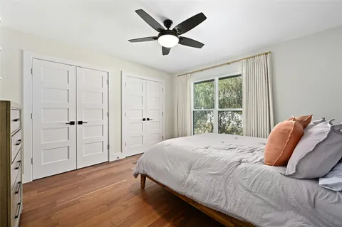 a bedroom with a bed and a large window