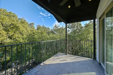 a view of a balcony with floor to ceiling windows and wooden floor
