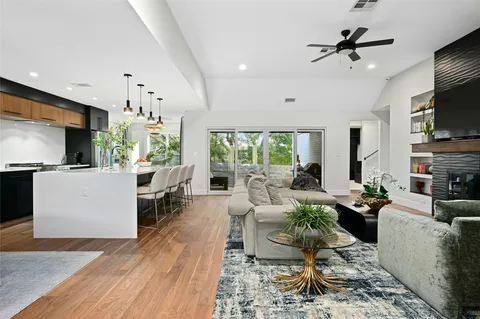 a living room with fireplace furniture and a flat screen tv