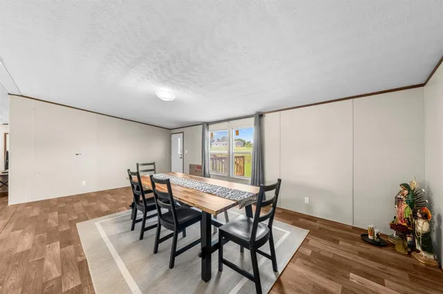 a kitchen with a table chairs refrigerator and microwave