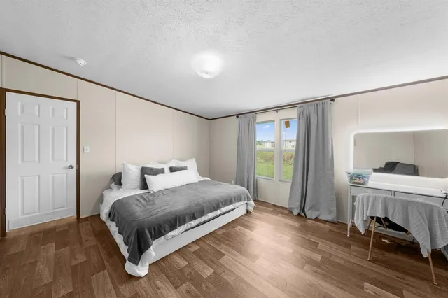 a bedroom with a bed and a couch