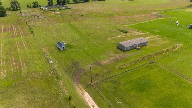 an aerial view of a residential houses with outdoor space