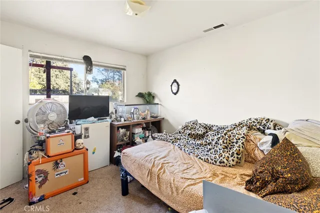 a bedroom with a bed and flat screen tv