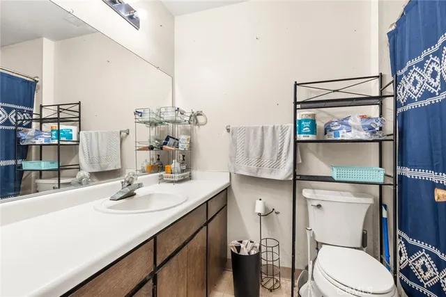 a bathroom with a sink vanity mirror and toilet