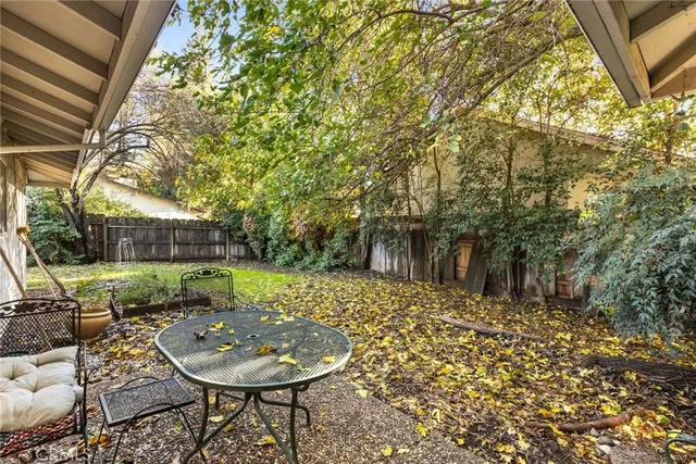 a view of a house with yard and sitting area