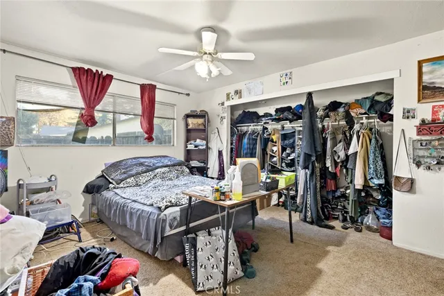 a bedroom that has a bed and a chandelier