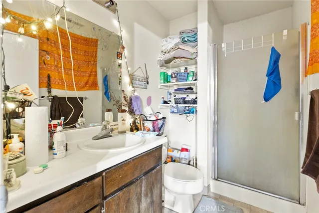 a bathroom with a sink vanity granite and toilet
