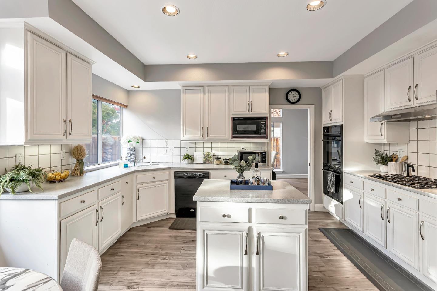 1173 Eagle Ridge Way Milpitas, CA 95035 - Photo 10 of 30 a kitchen with white cabinets and stainless steel appliances