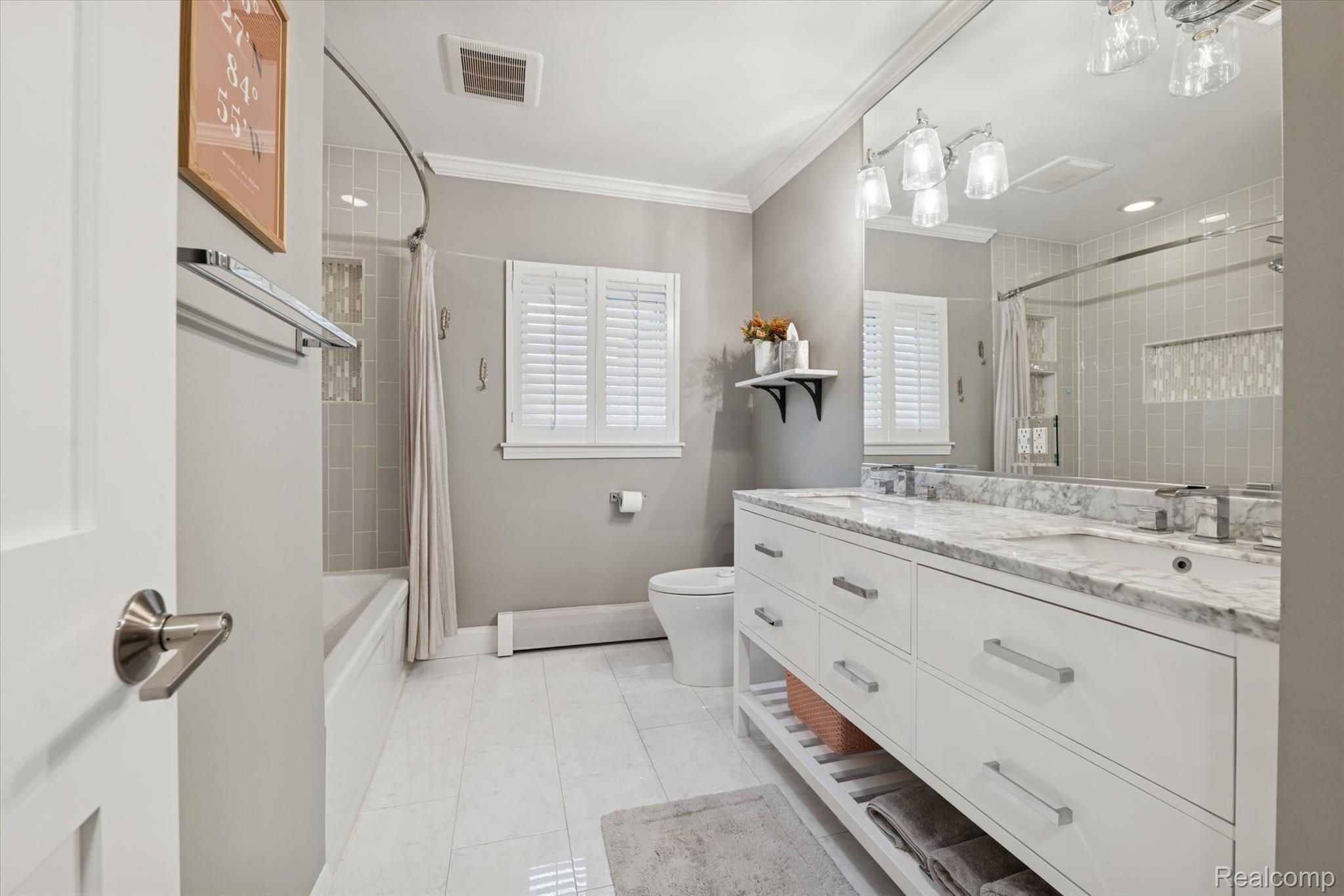 5100 Oakhill Road Clarkston, MI 48348 - Photo 29 of 54 Full bath with double vanity, ornamental molding, light tile patterned floors, and shower / bath combination with curtain