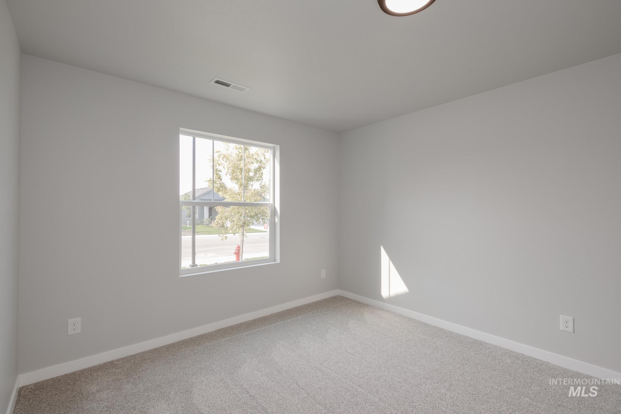 3304 West Morere Drive Meridian, ID 83642 - Photo 15 of 28 Spare room featuring carpet floors and baseboards