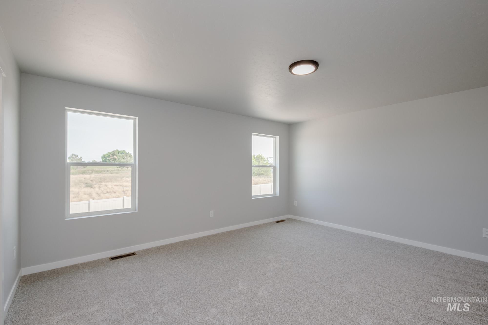 3304 West Morere Drive Meridian, ID 83642 - Photo 17 of 28 Unfurnished room featuring light carpet and baseboards