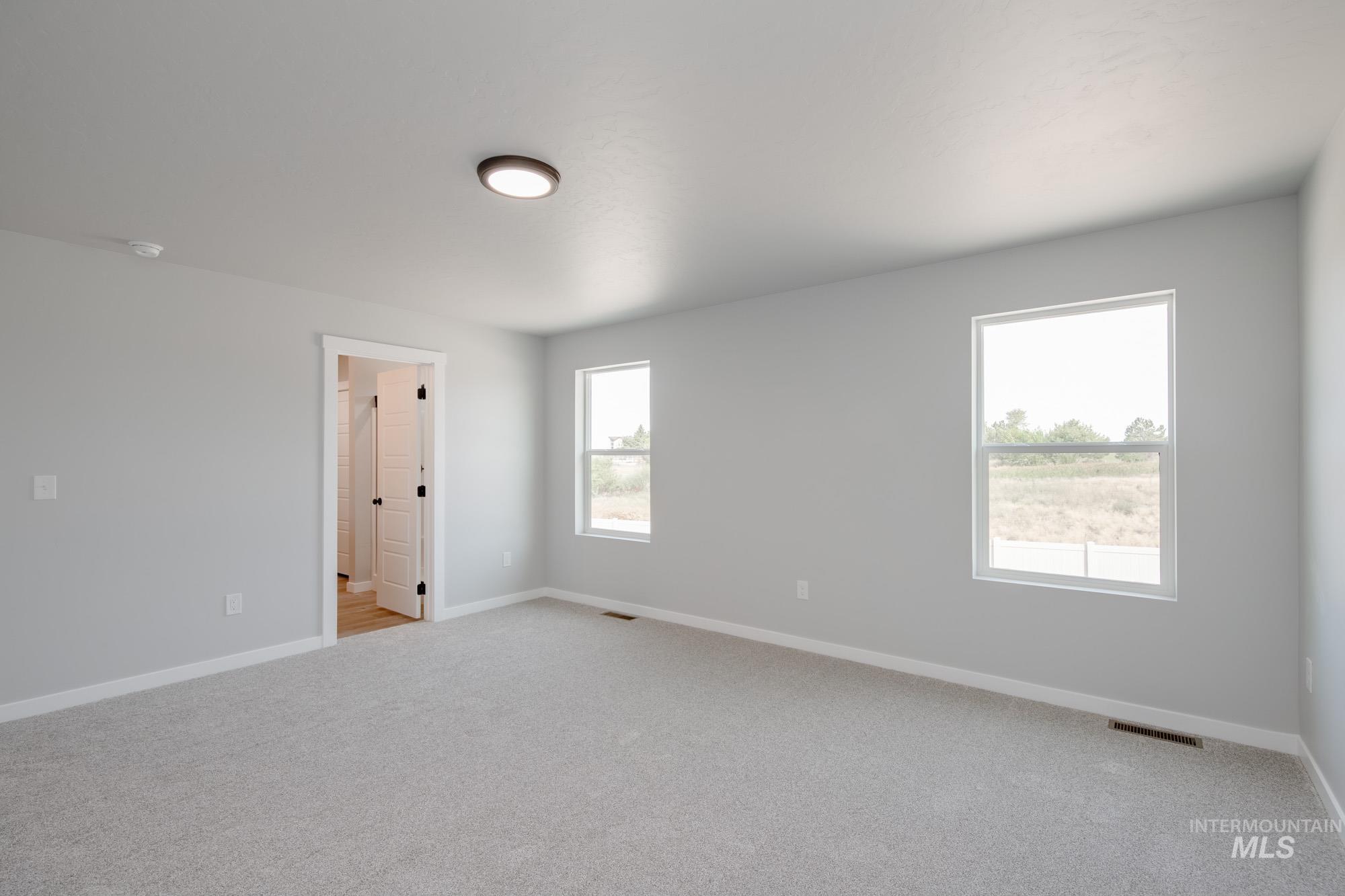 3304 West Morere Drive Meridian, ID 83642 - Photo 18 of 28 Unfurnished room with baseboards and light carpet