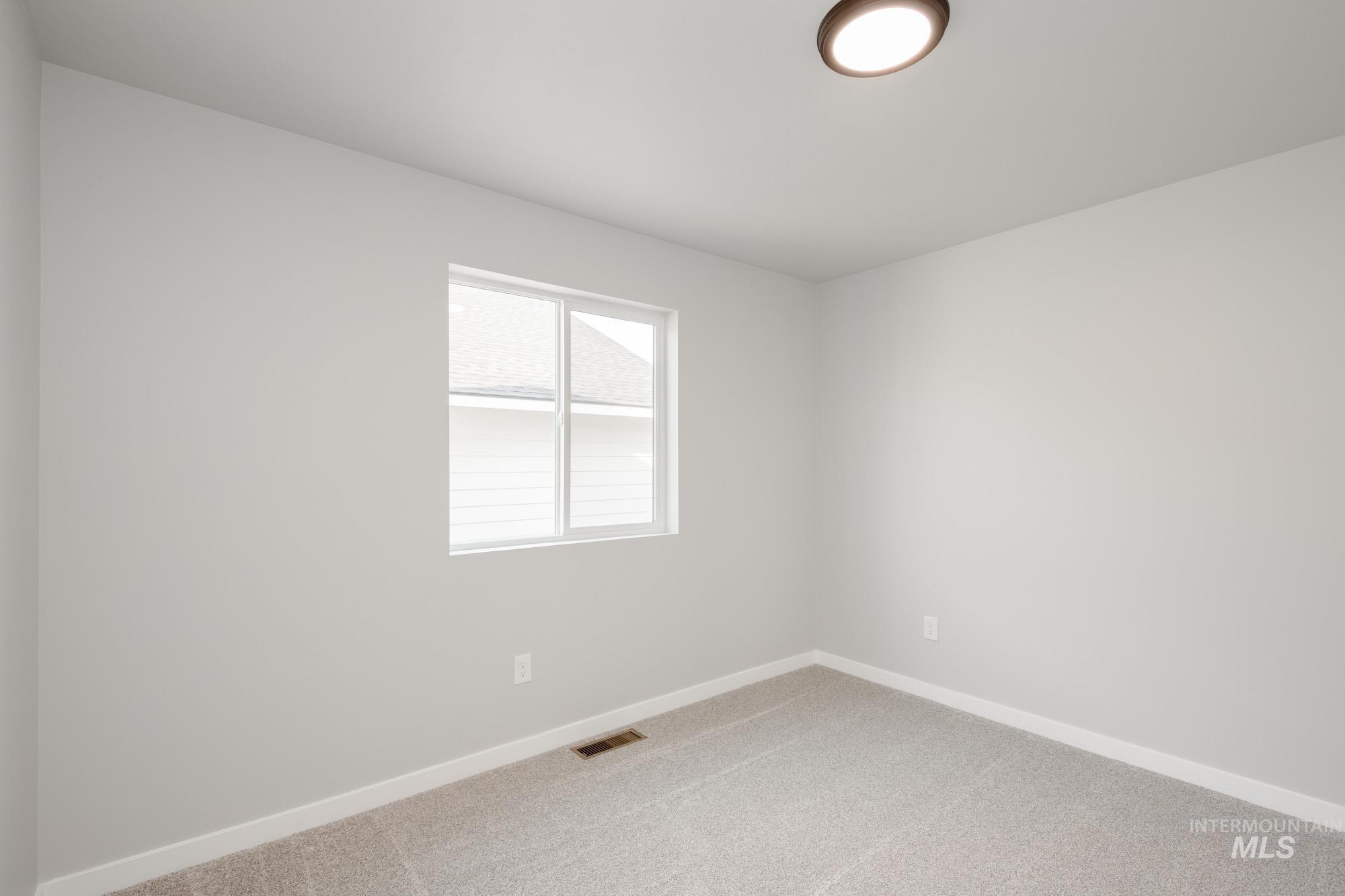 3304 West Morere Drive Meridian, ID 83642 - Photo 22 of 28 Carpeted empty room featuring baseboards