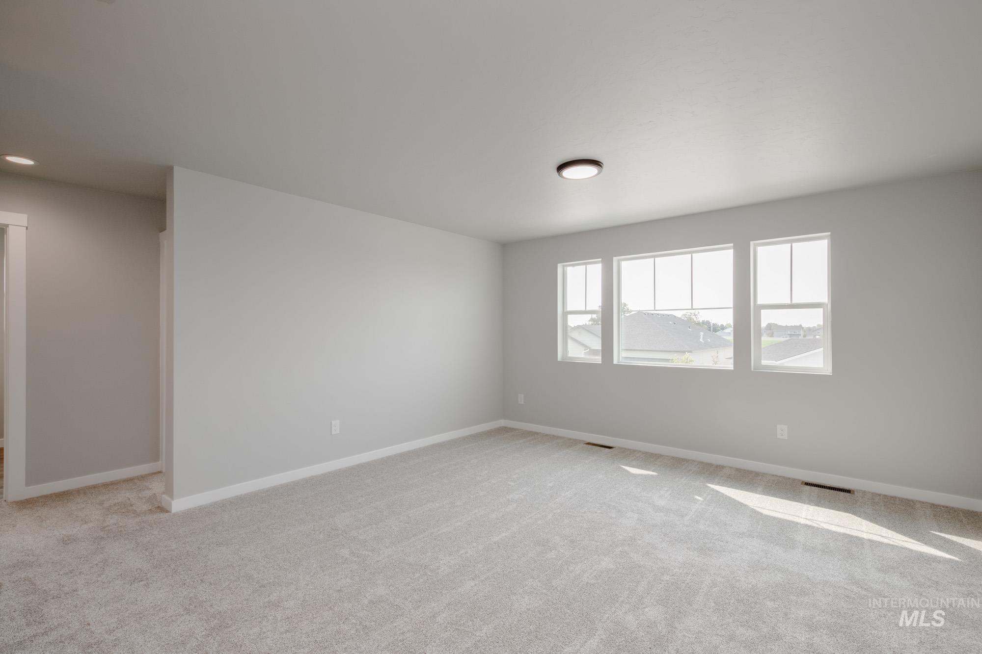 3304 West Morere Drive Meridian, ID 83642 - Photo 23 of 28 Empty room featuring light carpet and baseboards