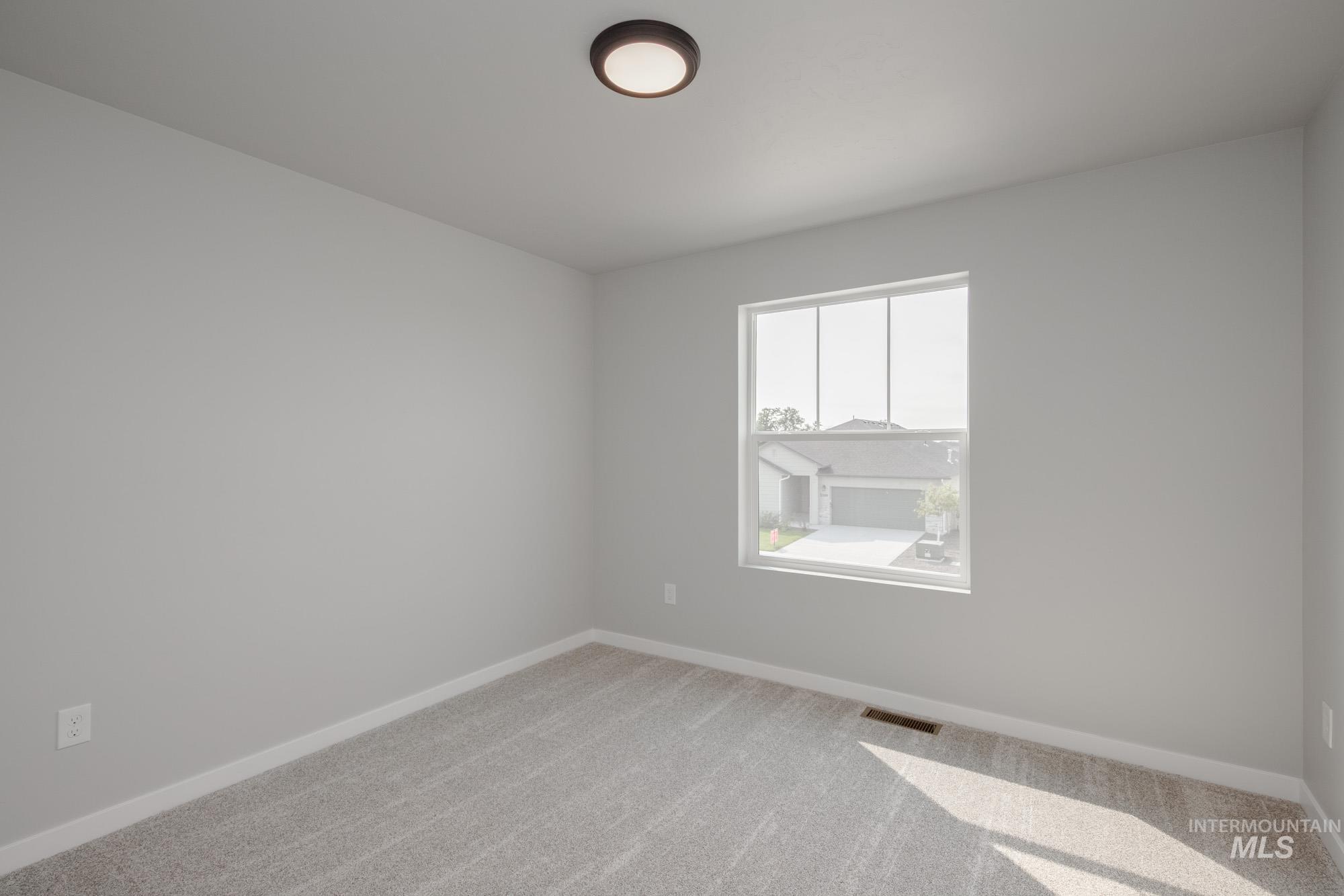 3304 West Morere Drive Meridian, ID 83642 - Photo 25 of 28 Carpeted spare room featuring baseboards